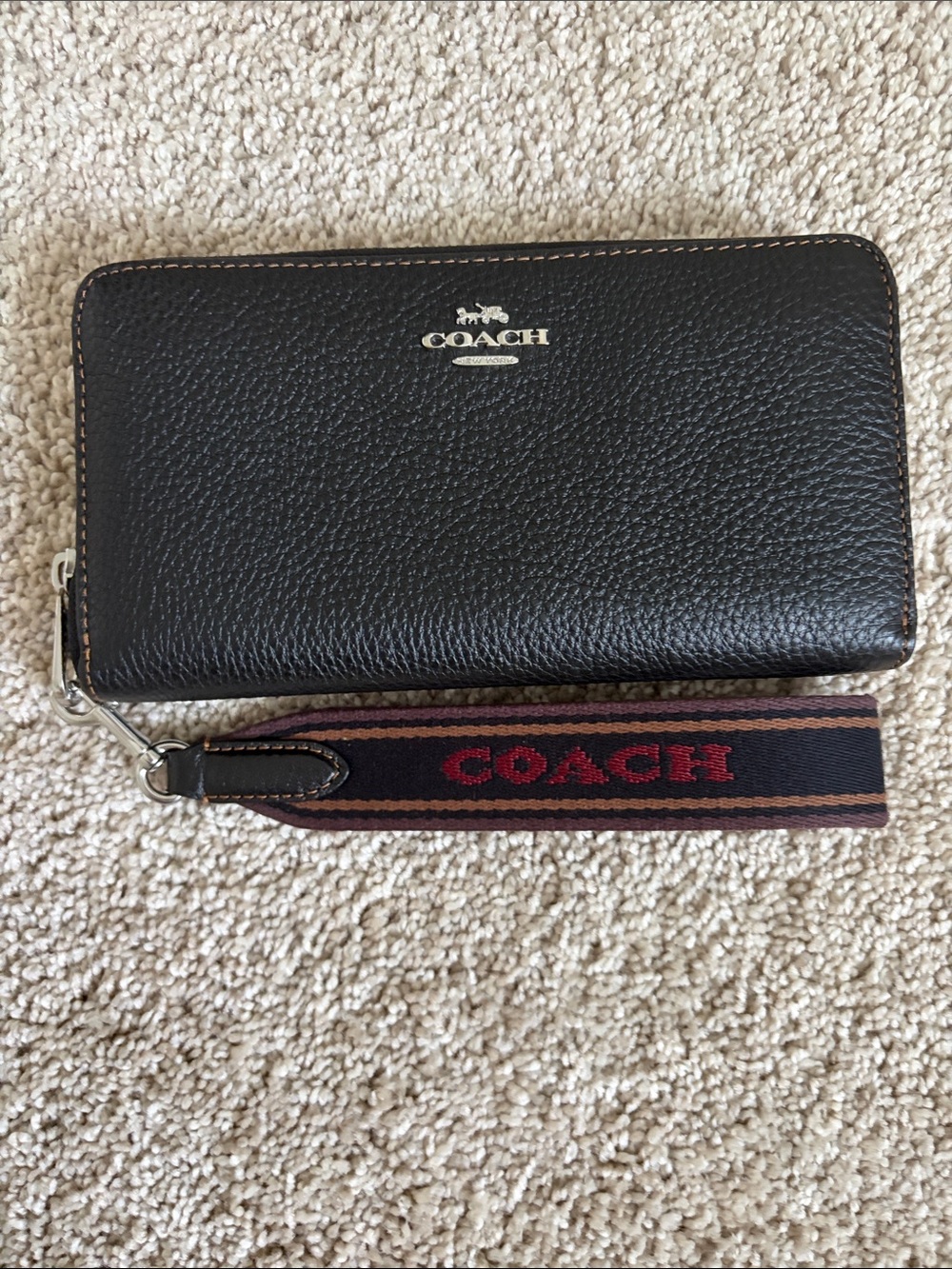COACH Long Zip Around with the  Varsity Webbed strap in Black Pebbled